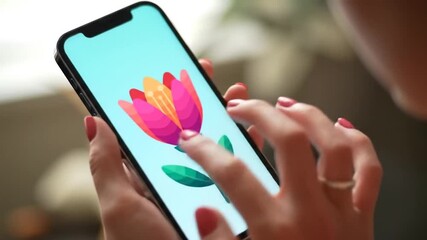 Close Up Of a Woman's Hand Holding a Phone with Digital Pink Flower On Blue Screen Display Blurred Backdrop - Powered by Adobe