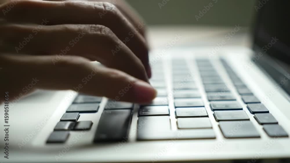 Aufkleber person typing on laptop keyboard with focused depth of field in white minimalist setting
