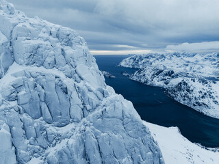 Breathtaking Aerial View Showcasing Icy Mountains Surrounded by Serene, Tranquil Waters