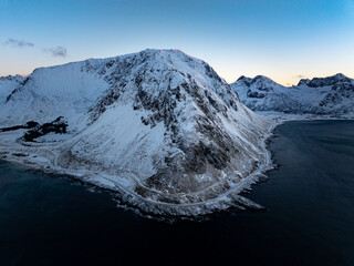 A Majestic SnowCapped Mountain Standing Tall Overlooking Tranquil Calm Waters Below