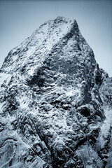 Majestic snowcapped mountain peak surrounded by dramatic lighting and stunning scenery