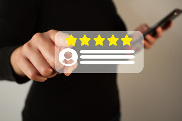 Business person's hand holding a cell phone while pointing at a five-star customer service rating