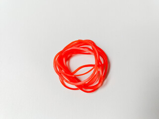 A collection of red rubber bands isolated on a white background.
