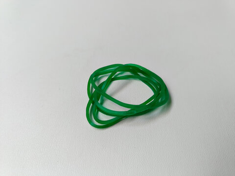 A collection of green rubber bands isolated on a white background.