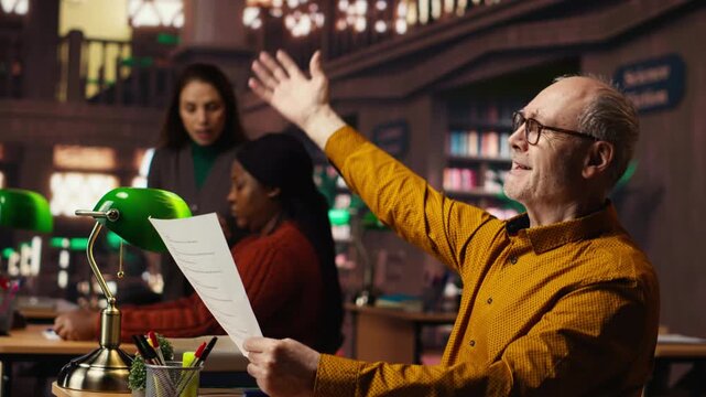 Elderly actor in a library focusing on script reading and memorization, preparing for a classic drama play with dedication and passion for theatre performance. Dramatic arts. Camera B.