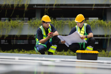 Team technicians and engineers working installing and inspection standards of solar panels on roof...