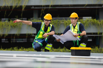 Team technicians and engineers working installing and inspection standards of solar panels on roof...
