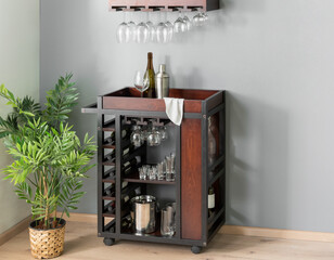 Industrial-inspired rolling bar cart with dark wood panels, metal frame, integrated wine rack,...