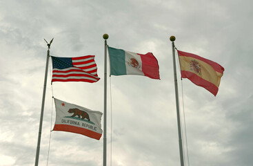 United States and California Flag together with those of Mexico and Spain