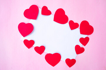 blank paper with red heart frame on pink background