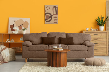 Comfortable sofa, table and poufs in interior of living room