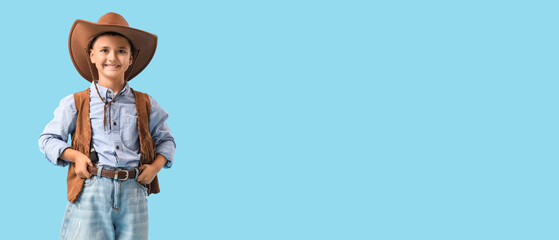 Cute little cowboy on blue background