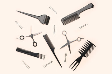 Hairpins with brushes and scissors on beige background