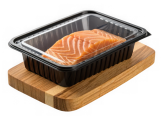 Fresh raw salmon fillet in clear plastic packaging on a wooden cutting board isolated on transparent background