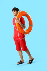 Male lifeguard with ring buoy on blue background