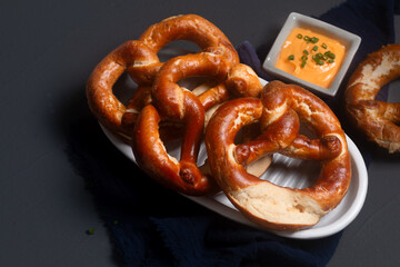 Food concept soft pretzel on black background with copy space