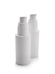 Bottles of makeup foundation on white background