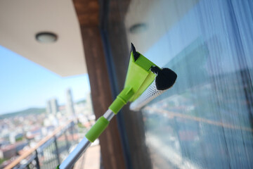 Cleaning windows on a high-rise building in a city