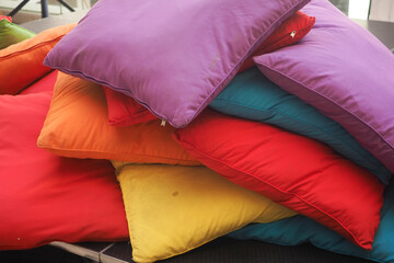 Colorful cushions stacked in a cozy living space