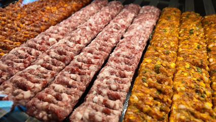 Grilled meat skewers displayed at a market food stall