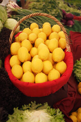 Fresh lemons displayed in a vibrant market basket