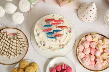 Cake with sweets for birthday party on table