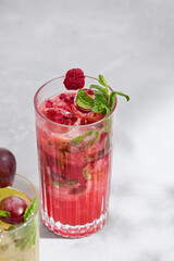 Raspberry mint lemonade vibrant bright closeup, refreshing beverage in tall glass on minimal...