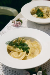 Potato vareniki with dill garnish, bright natural lighting, overhead composition, traditional Russian cuisine