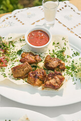 Pork shashlik on white plate, bright natural light, overhead composition, fresh summer vegetable...