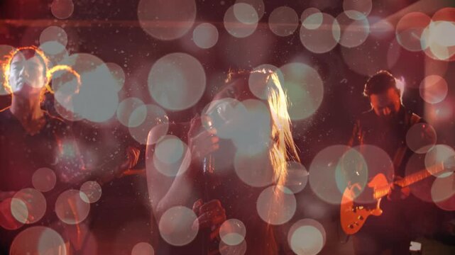 Music lighting fading in sparking singer flipping hair singing guitar duo strumming amid bokeh