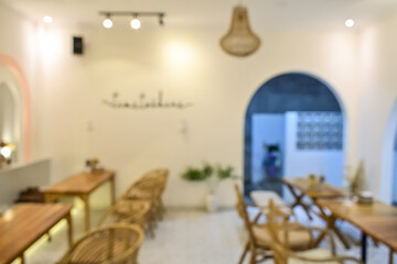 Blur bokeh background of interior with empty table and chair in restaurant, eatery, cafe or coffee shop. Abstract bokeh of food business dining court with no person. blurred.