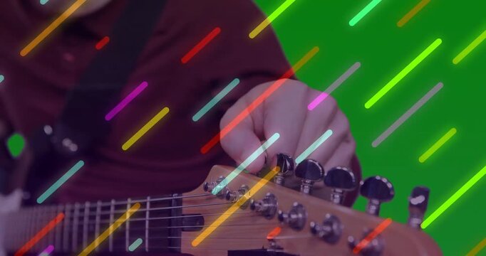 Guitarist fine-tuning pegs with hand entering frame, ensuring precise pitch with overlays for music