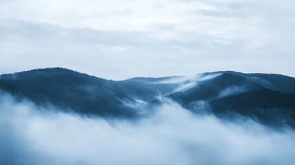 Misty mountain range in muted blues and grays