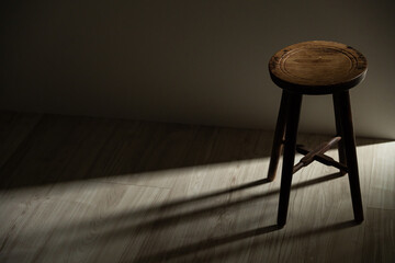 Minimal wooden chair in dark interior