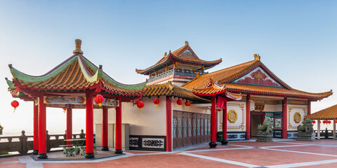 Chin Swee Caves Temple, Genting Highlands, Malaysia. Panoramic view of traditional Chinese temple architecture with ornate roofs, red pillars, and lanterns