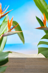 Vertical composition with tropical greenery surrounding wooden base and beach view. This clean and...