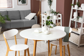 Tea set on dining table in living room interior