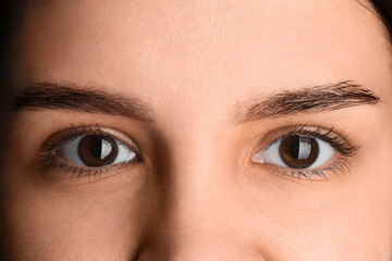 Fototapeta premium Young woman with brown eyes, closeup