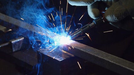 Welding, fascinating process, produces bright sparks and blue smoke as metal pieces are fused, grinder tool, highlighting the artistry, skill needed to create strong connections in industrial setting