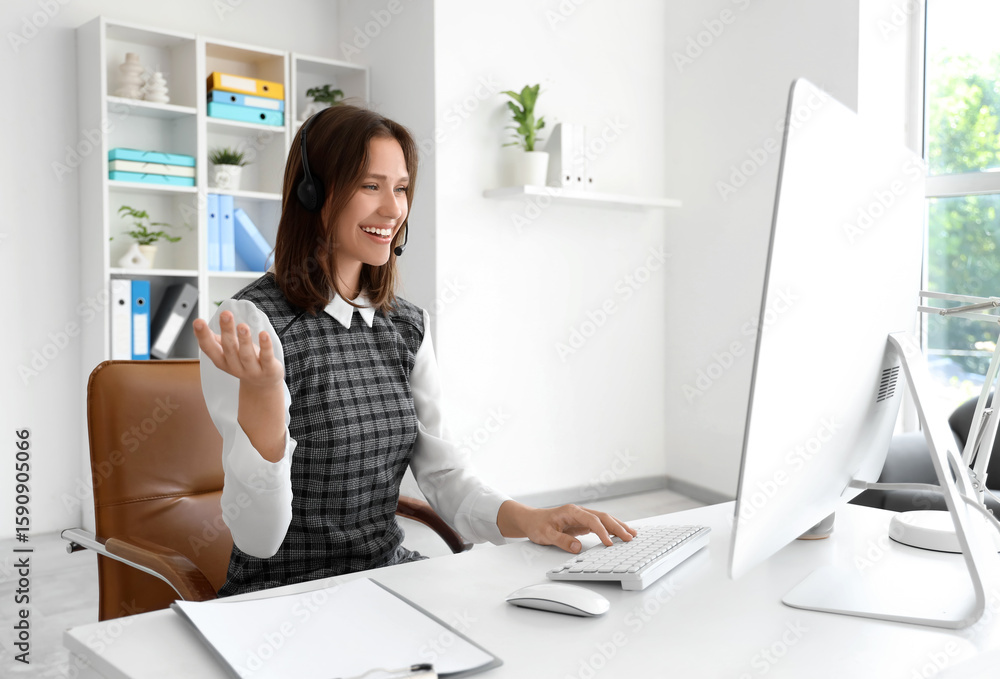 Poster female technical support agent in headset working with computer at office