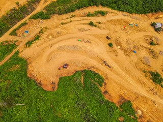 A tractor is mining rocks and sand as seen from the air, around an agricultural area, in a rural area in East Kutai Regency, East Kalimantan, Indonesia.