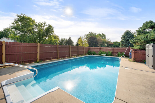 Basic Inground Pool with Concrete Deck and Surrounding Fence