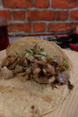 Vertical close-up shot of a carnitas taco with onion and cilantro, Mexican food