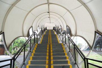 The stairs up with a closed roof, function as a pedestrian bridge.