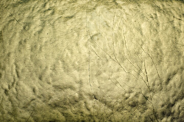 A rough golden textured surface with an abstract pattern and subtle lighting gradients. Ideal for luxury backgrounds, premium packaging, elegant branding, or creative abstract artwork