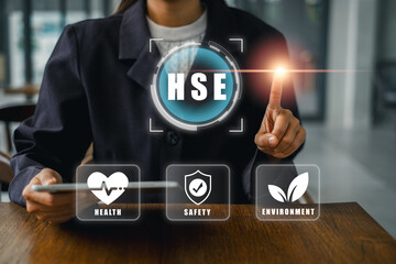 Businesswoman interacting with HSE digital interface emphasizing health, safety, and environment in...