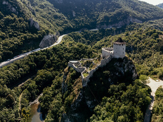 Aerial view of medieval hilltop fortress near Uzice, Serbia, surrounded by forest and mountains. C.