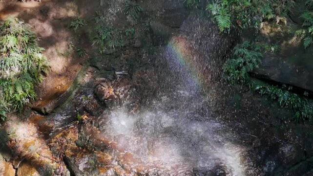 Blue Mountains, NSW, Australia: HD Drone Video -Close up with a rainbow to the beautiful Junction Falls in Australian rainforest on the South Lawson's 5 Waterfalls Circuit walking track.