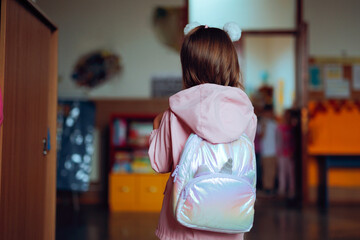 Little Student Girl Ready to Enter Classroom at School. Schoolchild going back to school being late...