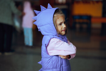 Unhappy Little Girl Feeling Angry with Arms Crossed. Upset child being in conflict with her...